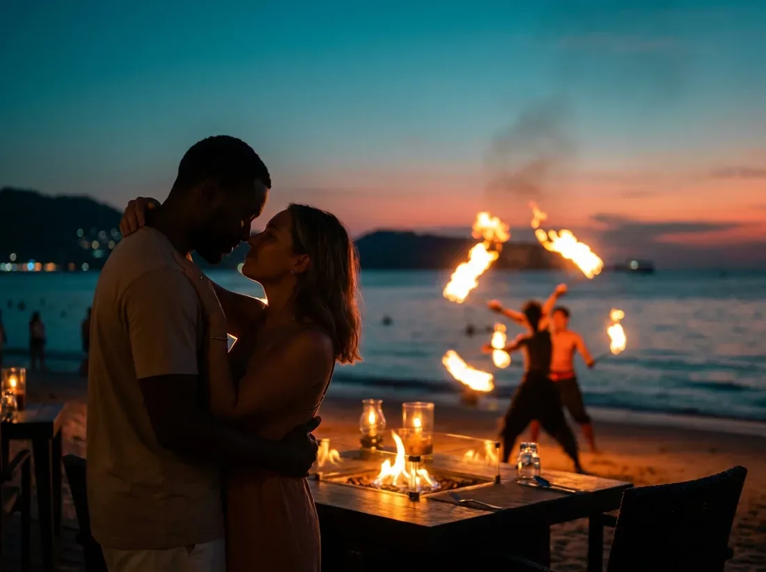 Candle-lit setup for a beach fire show performers night flames couple silhouette in Phuket