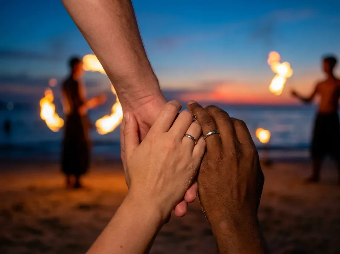 Close-up detail of a beach fire show performers night flames couple silhouette in Phuket